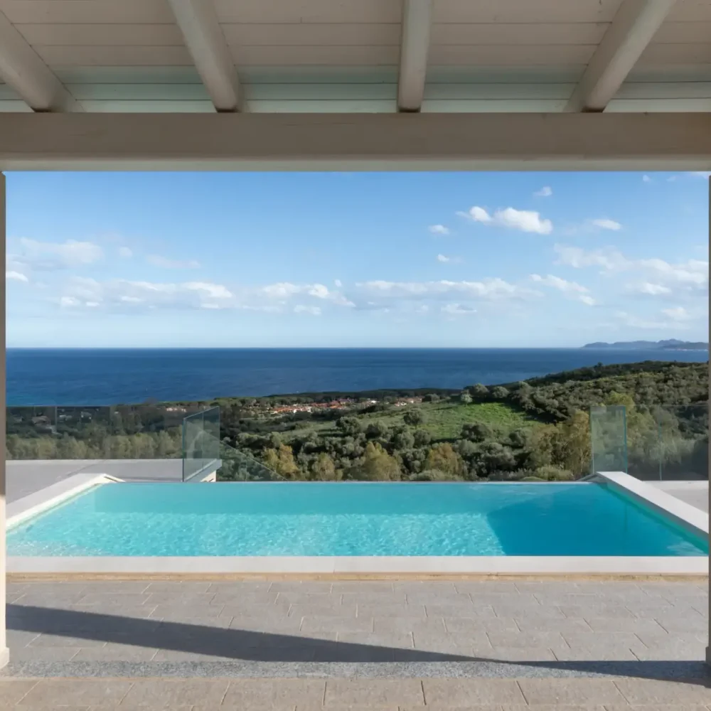 Infinity pool with panoramic sea view framed by a covered terrace