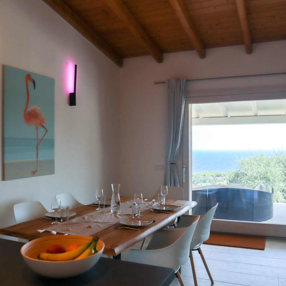 Living room with dining table and sea view.